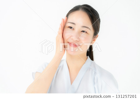 Woman touching her cheek beauty 131257201