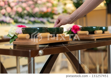 The hands of a young woman offering incense at a funeral home The hands of a young woman offering incense at a funeral home 131257451