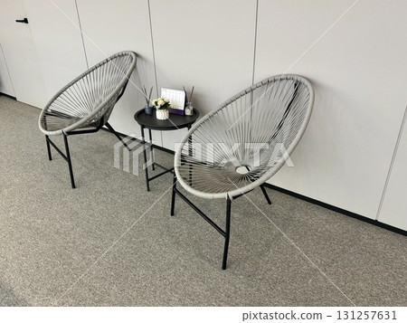 A relaxation area with two chairs and a table in a modern office in the city 131257631
