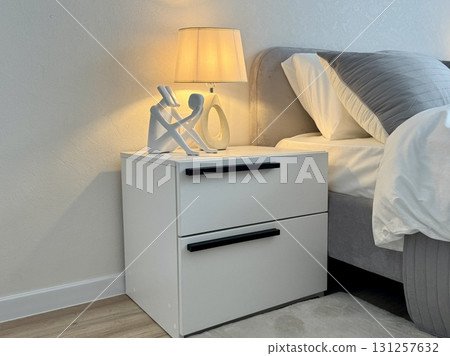 A white bedside table for a modern and stylish interior in a new apartment A white bedside table for a modern and stylish interior in a new apartment 131257632