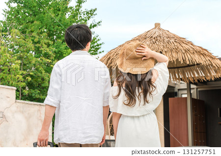 Young Asian couple walking in a tropical resort (travel, honeymoon, vacation) 131257751