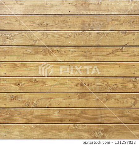 Square background image of light brown boards with grain and knots planked with round-head brass nails Square background image of light brown boards with grain and knots planked with round-head brass nails 131257828