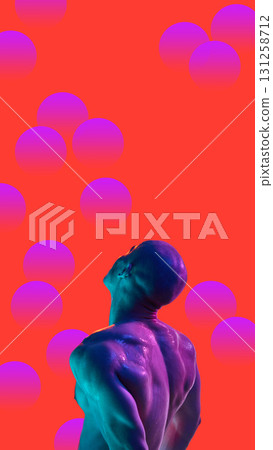 Bold poster. Muscular man with neon light on back looking upward against red background with violet spheres Bold poster. Muscular man with neon light on back looking upward against red background with violet spheres 131258712