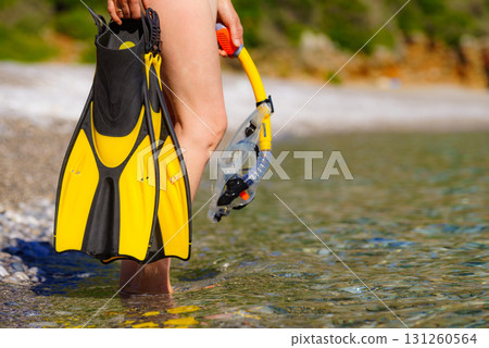 Woman with flippers snorkeling tube on beach Woman with flippers snorkeling tube on beach 131260564