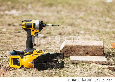 Drill tool next to piece of wood Drill tool next to piece of wood 131260637