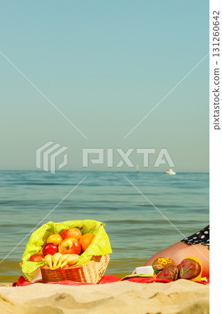 Picnic basket on blanket near sea Picnic basket on blanket near sea 131260642