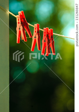 Red clothes pegs on string outdoor. Red clothes pegs on string outdoor. 131260847