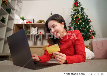 Christmas Online Shopping. Woman with credit card using laptop for holiday purchases. 131261106