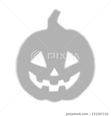 Silhouette of a round pumpkin, gray with blurred edges and carved creepy eyes and mouth. 131261135