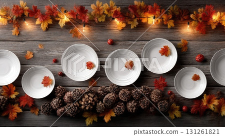 A festive table is set with yellow napkins, plates, pumpkins, and autumn leaves for a cheerful autumn ambiance 131261821