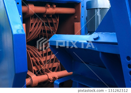 Industrial debarking machine with rotating components on woodworking plant. Industrial debarking machine with rotating components on woodworking plant. 131262312