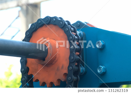 Orange metal gear mechanism rotating on industrial plant factory. Orange metal gear mechanism rotating on industrial plant factory. 131262319