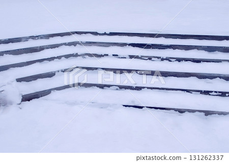 Steps in the snow at entrance to the building in winter, slippery stairs. 131262337
