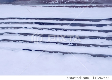 Steps in the snow at entrance to the building in winter, slippery stairs. 131262338