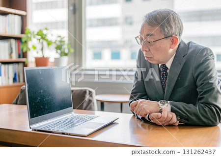Businessman staring at a personal computer 131262437