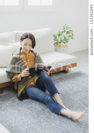 A woman using a tablet in the living room 131262845