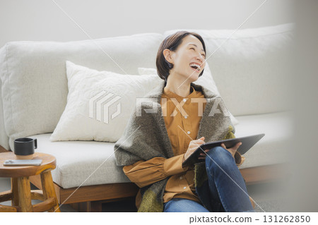 A woman using a tablet in the living room 131262850