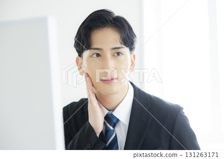 A man in a suit looking in the mirror A man in a suit looking in the mirror 131263171