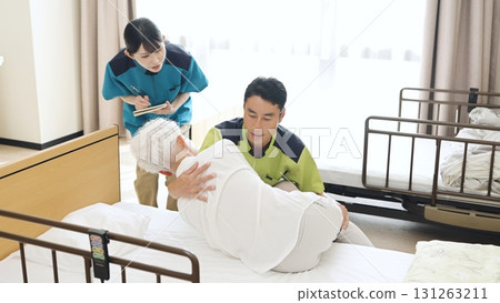 Asian caregiver instructing how to change positions 131263211