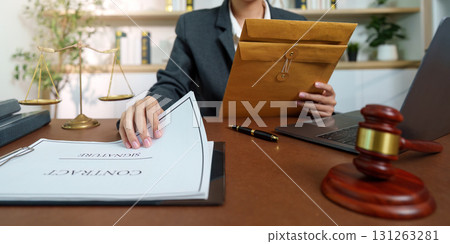 Legal Professional Reviewing Contract Documents with Gavel 131263281