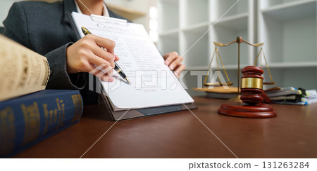 Lawyer Signing Important Legal Agreement in Office 131263284