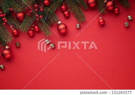Red Christmas background with fir branches, red baubles and decorations. Red Christmas background with fir branches, red baubles and decorations. 131263577