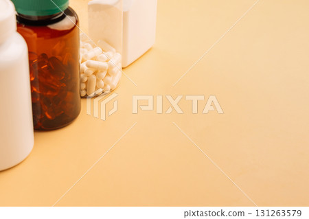 Assorted supplement bottles on beige copy space wellness concept 131263579