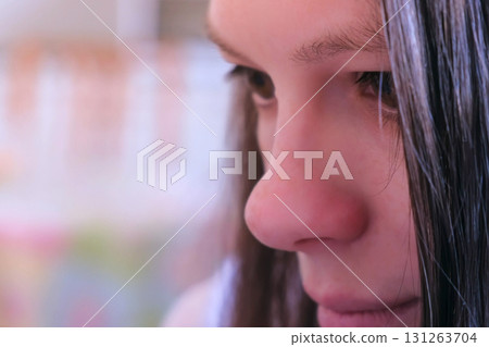Closeup face of young girl with moving eyes reading something. Closeup face of young girl with moving eyes reading something. 131263704