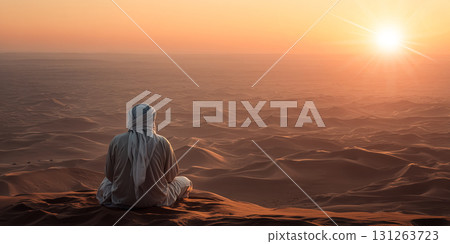 An Arab Man Sitting on a Sand Dune Contemplating the Desert at Sunset - Generative Ai An Arab Man Sitting on a Sand Dune Contemplating the Desert at Sunset - Generative Ai 131263723