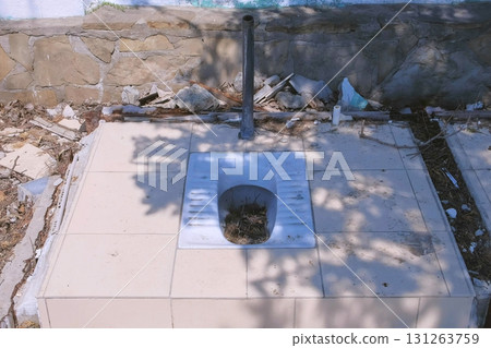 Dismantling of the old outdoor toilet in the Park of the resort town. 131263759