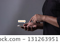 Customer Review, Young Man hand holding Smart Phone with five star to review and give 5 stars  131263951