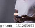 Customer Review, Young Man hand holding Smart Phone with five star to review and give 5 stars  131263953