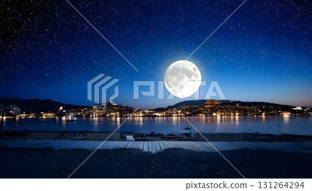 Serene nighttime scene with a full moon and a quiet city, symbolizing restful sleep 131264294