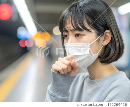 Woman wearing a mask while waiting for a train feels unwell Woman wearing a mask while waiting for a train feels unwell 131264416