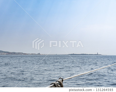 Tarifa island and lighthouse as seen from a sailboat in the straits of Gibraltar 131264593