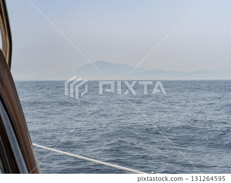 African mountains seen from a sailboat sailing through the straits of Gibraltar African mountains seen from a sailboat sailing through the straits of Gibraltar 131264595