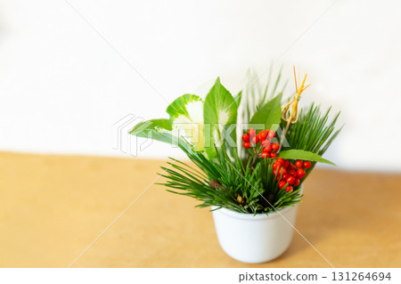 New Year's flower arrangement of red nandina berries, pine, and chrysanthemums New Year's flower arrangement of red nandina berries, pine, and chrysanthemums 131264694