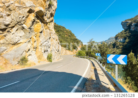 Scenic winding road by the Sobron reservoir in Burgos, Spain. A picturesque mountain road with 131265128