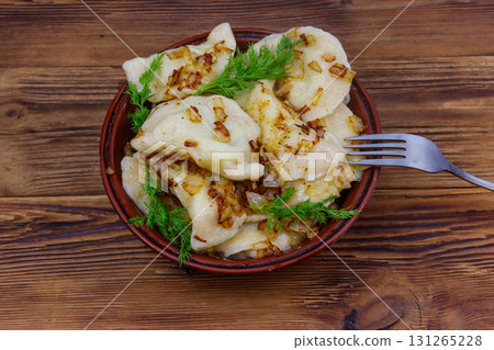 Delicious homemade dumplings on a wooden table 131265228