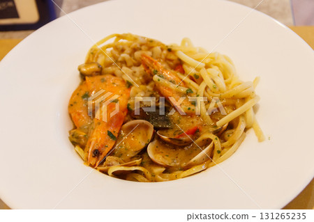 Pasta spaghetti with seafood and sauce on a table Pasta spaghetti with seafood and sauce on a table 131265235