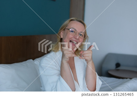 poor eyesight woman wearing glasses age confident asian woman showing thumb up in approval, recommending, like smth good, standing over white background 131265465