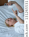 Senior adult woman waking up in the morning taking and wearing optical glasses. Old grandmother having bad weak sight, elderly vision problem. Visually impaired elder person concept. Close up view 131265531