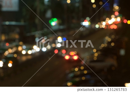 Blurred night city traffic with illuminated building and cars on road. Blurred night city traffic with illuminated building and cars on road. 131265783