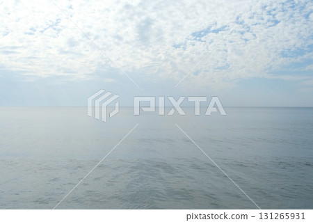 Calm ocean waves under cloudy sky in soft blue colors. 131265931