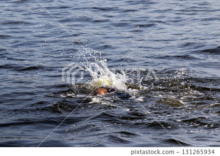 Swimmer Splashes in Calm Waters During Midday Activity 131265934