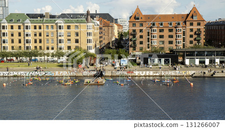Colorful Kayak Boats Navigate the Vibrant Waterfront on a Sunny Day 131266007