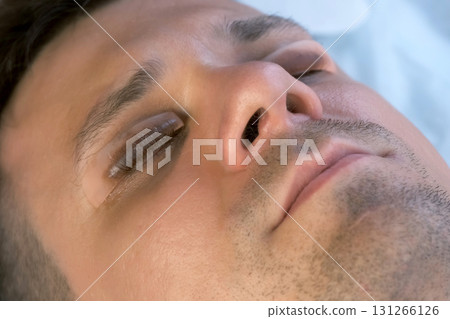 Young man on lash lifting laminating procedure in beauty clinic with close eyes. Young man on lash lifting laminating procedure in beauty clinic with close eyes. 131266126