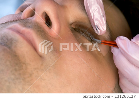 Cosmetologist bending lashes with needle into curlers, lift eyelashes laminaton. Cosmetologist bending lashes with needle into curlers, lift eyelashes laminaton. 131266127