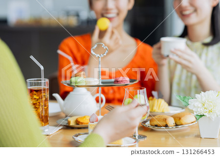 Young woman enjoying afternoon tea at a cafe 131266453