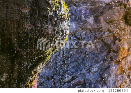 Small water stream on a rock after the rain. Close-up view. Small water stream on a rock after the rain. Close-up view. 131266864